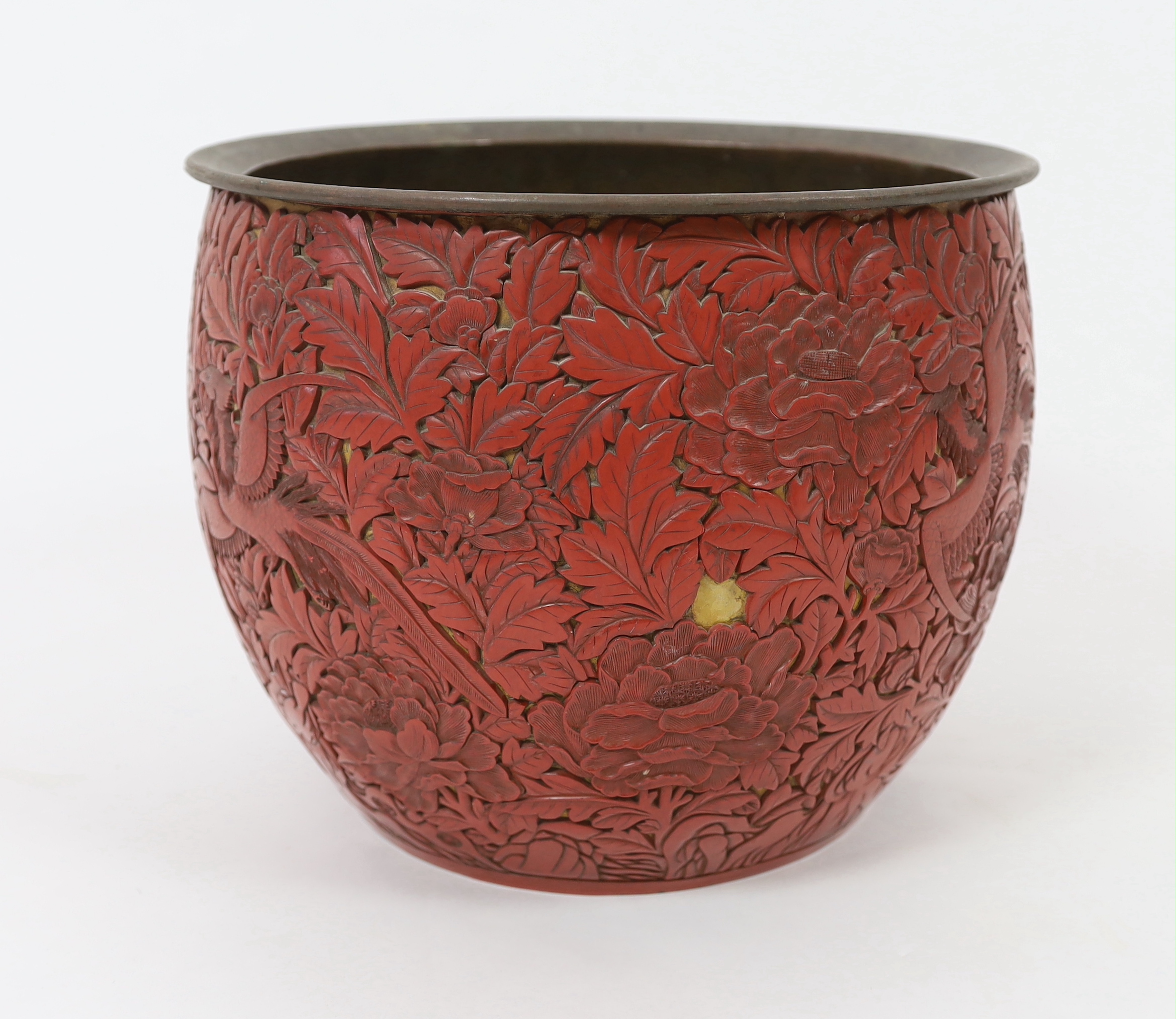 A large Chinese cinnabar lacquer ‘pheasant and peony’ jardiniere, 19th century, losses and numerous loose sections